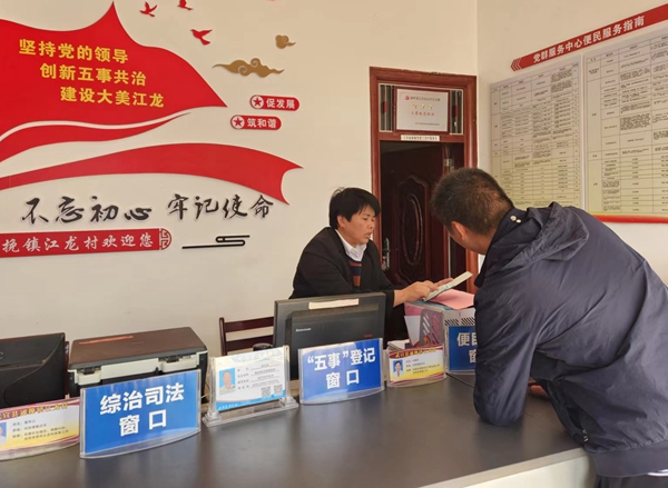 在“五事”登记窗口，工作人员为村民解答问题。人民网 黄子婧摄
